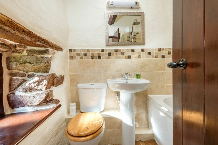 Bathroom with 500 year old exposed pink Eskdale granite
